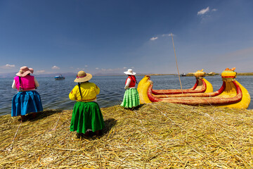 The Uros are an indigenous people who inhabit the floating islands on Lake Titicaca, which is located on the border between Peru and Bolivia. The Uros are known for their unique way of life - obrazy, fototapety, plakaty