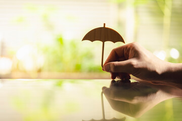 Hand of man holding an umbrella symbol. Insurance concept, Family life insurance and policy concepts