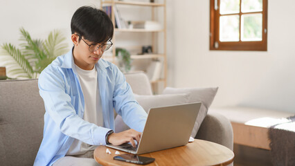 Fototapeta premium Business at home concept, Businessman typing on laptop about strategy and planning of new business