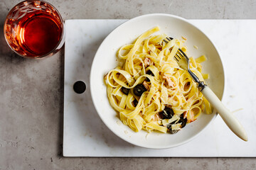 Tagliatelle pasta with tuna, olives and cheese.