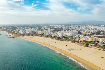 Aerial view of famous Portuguese city Portimao. View of beautiful La Rocha Beach. Beautiful panorama of all region. Famous travel destination in South of Portugal, Algarve region