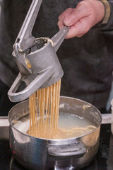 Preparation of Spätzle - Spaetzle, a Swabian type of noodle, preparation of food.