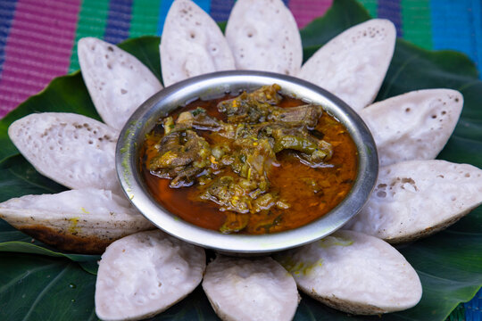Bangladeshi Traditional Aush or Porangi Rice Special  Delicious tasty Chitoi Pitha Decorated on the green leaf with Duck Curry Recipe