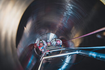 Top view male climbs up the stairs into the tank stainless chemical area confined space