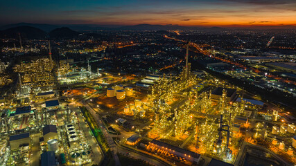 Aerial view of the morning of the oil refinery from the drone of the tower of the Petrochemistry industry in the oil​ and​ gas​ ​industry with​ cloud​ sun orange​