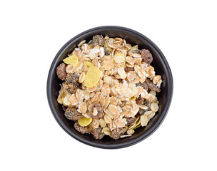 Grain muesli cereal in black bowl isolated on white background, top view