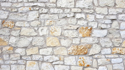 Old bright white pattern stone wall texture.