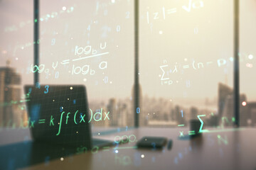 Double exposure of creative scientific formula concept and modern desktop with laptop on...