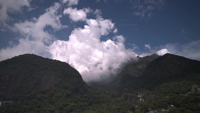 Hyperlapse approaching landscape with mountains in Teresopolis, Rio de Janeiro, Brazil with the iconic Dedo de Deus or Finger of God covered by clouds