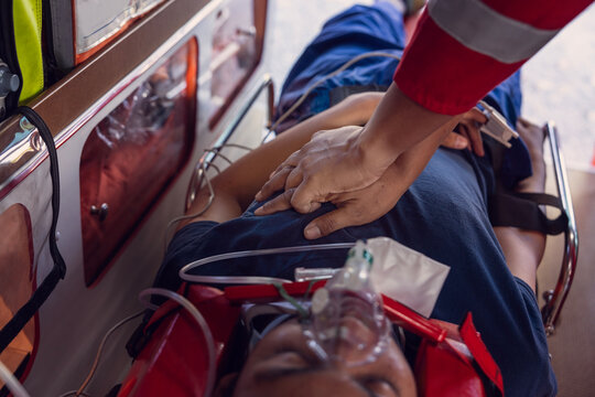 male paramedics are resuscitating To save cardiovascular lives, the rescue team uses their hands to perform CPR to save the lives of patients lying in the ambulance 