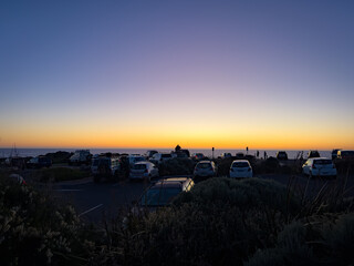 Man Enjoys the Sunset From the Top of His Car