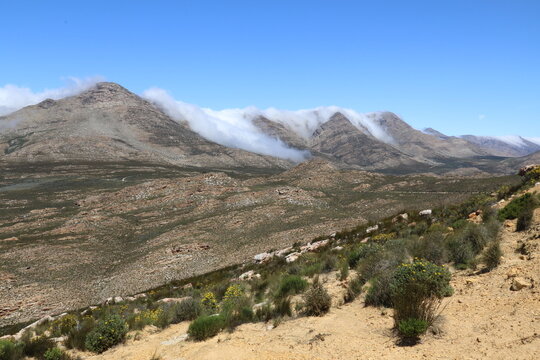 clouds creeping over the top of the Swartberg mountains