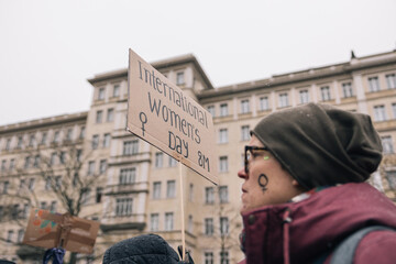 Woman with an International Women's Day banner at a demonstration in Berlin