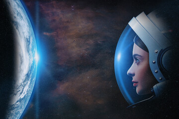 Attractive woman astronaut against Earth planet in outer space. Elements of this image furnished by NASA.