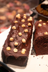 Chocolate cake with hazelnuts on a supermarket display.