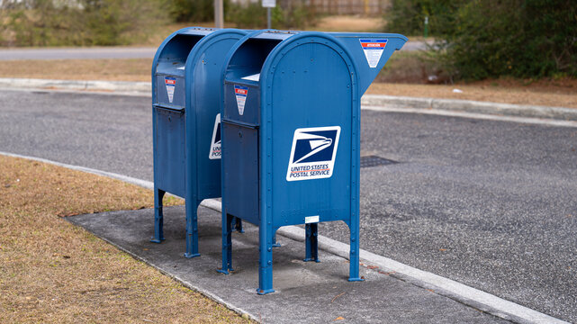 United States Postal Service collection boxes on a roadside.