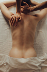 Fototapeta premium Hands of female chiropractor massaging shoulders of young woman lying on massage table. Concept of physical therapy treatment ,neck pressure point