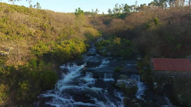 Aerial View Of Fervenza de Castriz, Castriz Waterfall By The River Mira In Santa Comba, Spain. - pullback shot