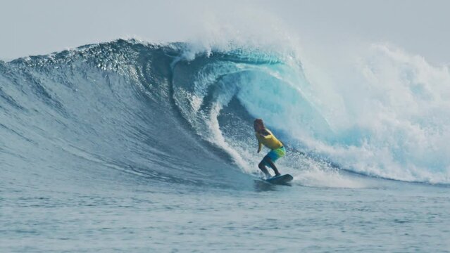 Beginner surfer rides big wave in the Maldives