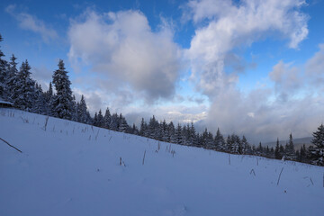 view of the mountains through the clouds in winter