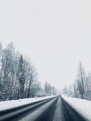 Fototapeta na wymiar Empty snowy asphalt road, winter
