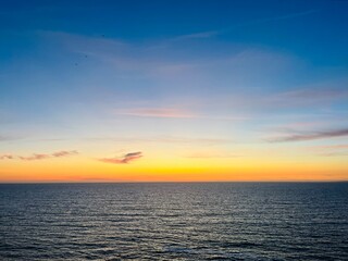 Ocean and purple sky at the ocean bay, orange ocean horizon