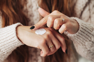 Skin care background. Hand cream use. Closeup of wet skin. Spa cosmetics background. Hands moisturizing. Body lotion on hands. Caucasian female lifestyle applying cream.