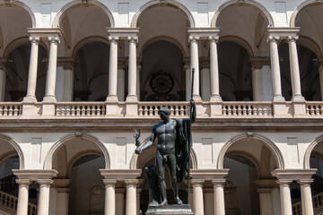 Fototapeta premium Milan, Italy, July 31, 2023. The bronze statue to Napoleon Bonaparte sculpted by Antonio Canova, in the courtyard of the Palace of Brera at Milan.