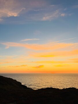 Ocean and purple sky at the ocean bay, orange ocean horizon