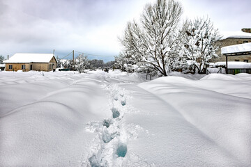 Fototapeta premium Rural street covered with fresh very deep snow