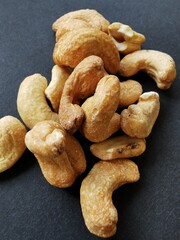 Cashew nuts on a black background, taken close up.