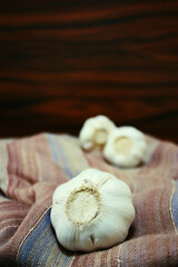 Garlic bulb closeup. Garlics on the rustic fabric.