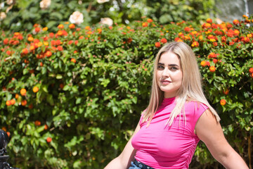 Portrait of young woman, blonde, green eyes, wearing pink t-shirt, looking at camera, pure,...