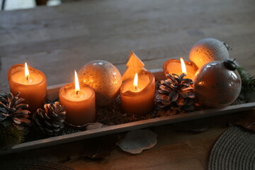 Table Christmas decoration with lit candles, warm light