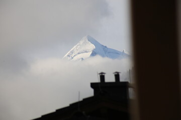 Tele shot of Kitzsteinhorn peak with chimney and clouds