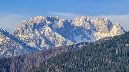 Panoramic view of snow covered mountain range Julian Alps seen from the Karawanks in Carinthia,...