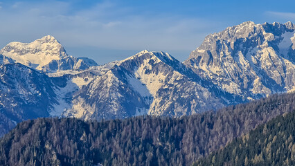 Panoramic view of snow covered mountain range Julian Alps seen from the Karawanks in Carinthia, Austria. Looking at mountain peak Triglav. Tranquil scene in alpine landscape in Slovenian Austrian Alps