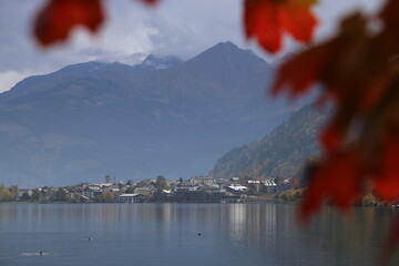 Lake Zell with Kitzsteinhorn and autumn foliage on trees, selective focus 