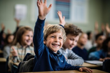 Young boy raising hand in elementary school classroom - obrazy, fototapety, plakaty