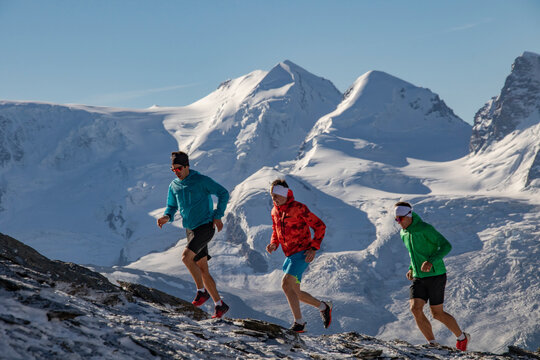 Mountain running trio in colorful attire
