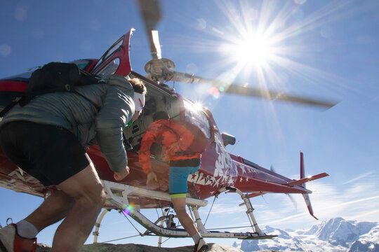 Skiers boarding a rescue helicopter