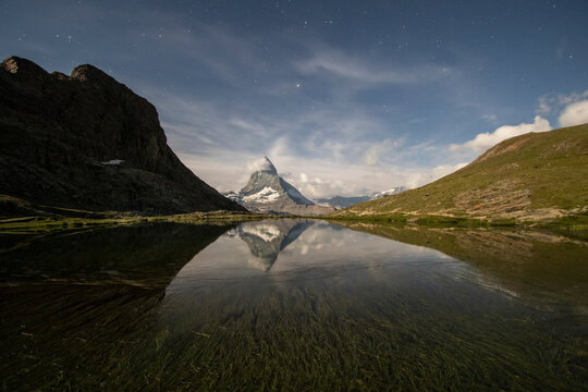 Majestic mountain reflection under starlit sky