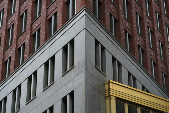 Abstract architectural detail of a modern corner building with contrasting yellow elements in Rotterdam