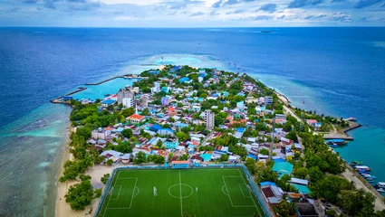 Foto op Plexiglas Drone Aerial View of Maldives Island in the Indian Ocean with Soccer Field In View and Blue Waters © Chris