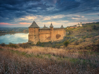 dark clouds  and sunset light above old fortress in Ukraine