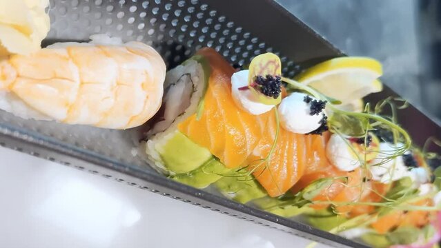 Sushi with salmon, cheese, herbs and smoke.