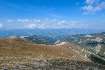 Panoramic view of Lavanttal Alps seen from Amerinkogel on Packalpe at border Carinthia and Styria, Austria. Remote alpine hill landscape in Austrian Alps. Wanderlust. Tranquil scene on meadows