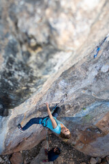 The sports girl is engaged in rock climbing