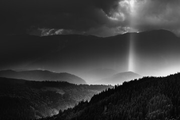 Amazing landscape of mountains hills in sunbeam and cloudy sky in black and white shadow light. Monochrome style. - 698743740