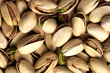 Close-up of pistachios creating a textured background, ideal for food-related themes.